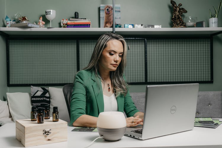 Blonde Woman Working On Laptop In Home Office