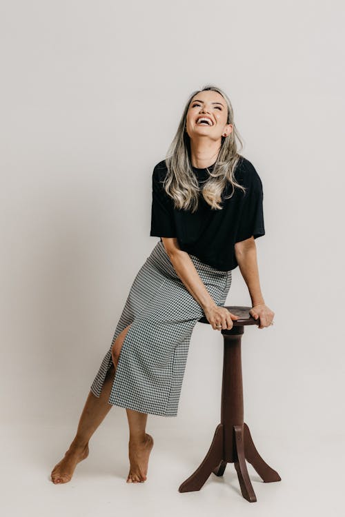 Laughing Blonde Woman in Skirt