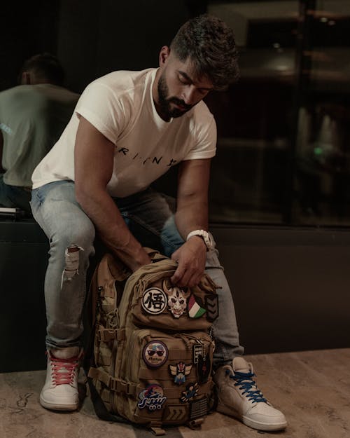 Man Sitting with Backpack