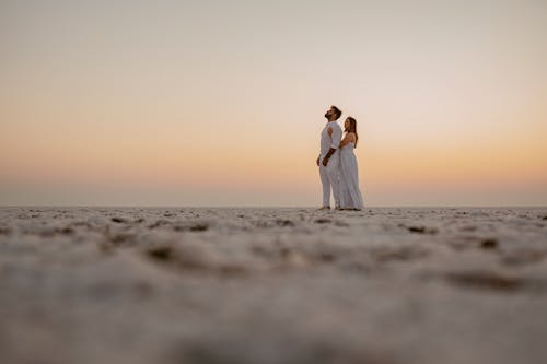 A Couple Hugging on the Beach at Dawn