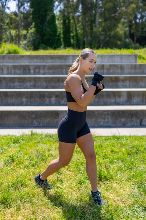 Muscular Female Athlete Shadow Boxing Outdoors in the Park