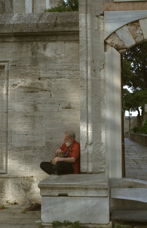 Elderly Man Sitting near Mosque Wall in Istanbul