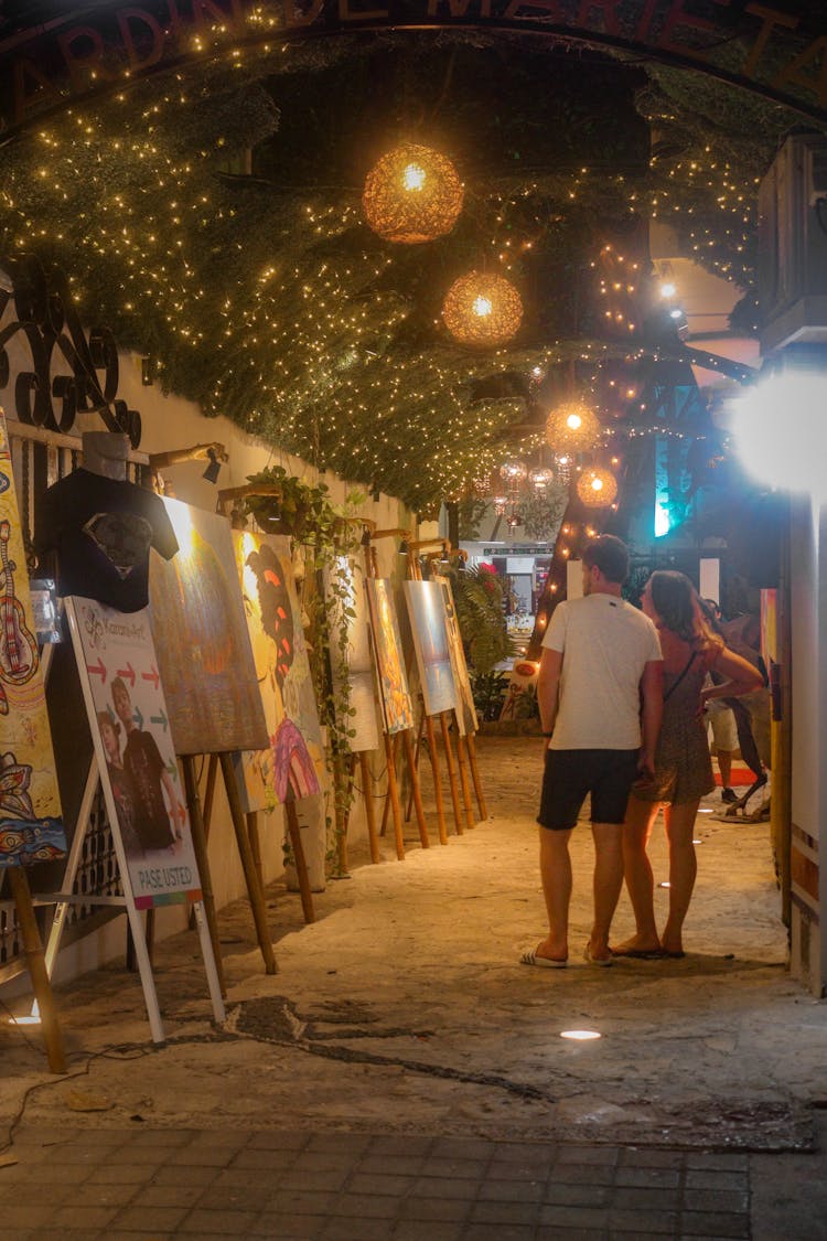 People Looking At Art Display