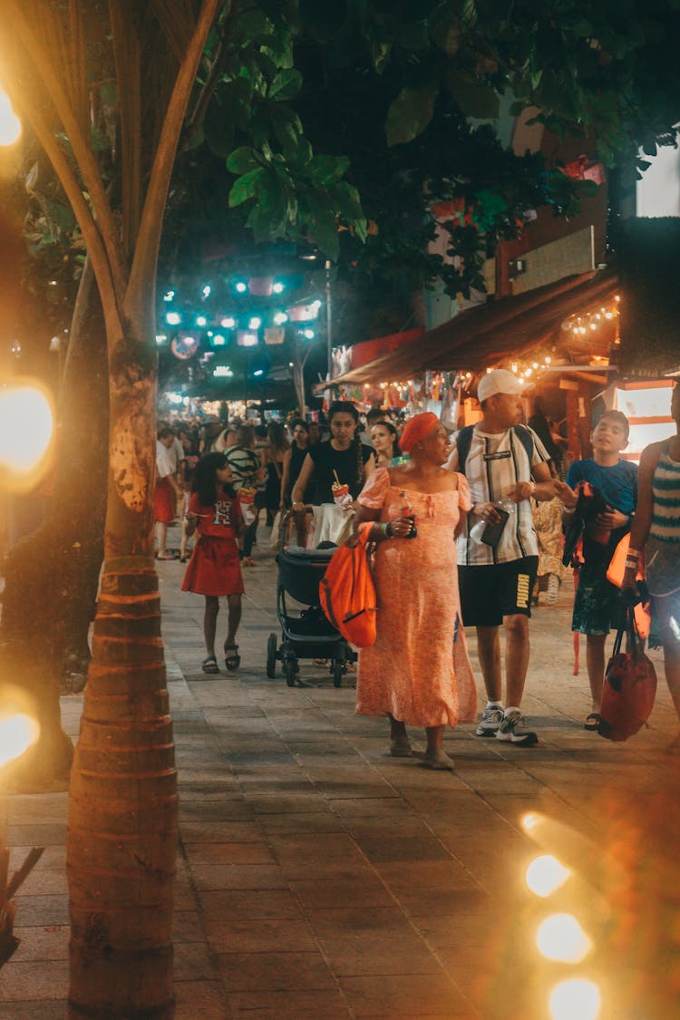 People Walking In Alley In Town At Night