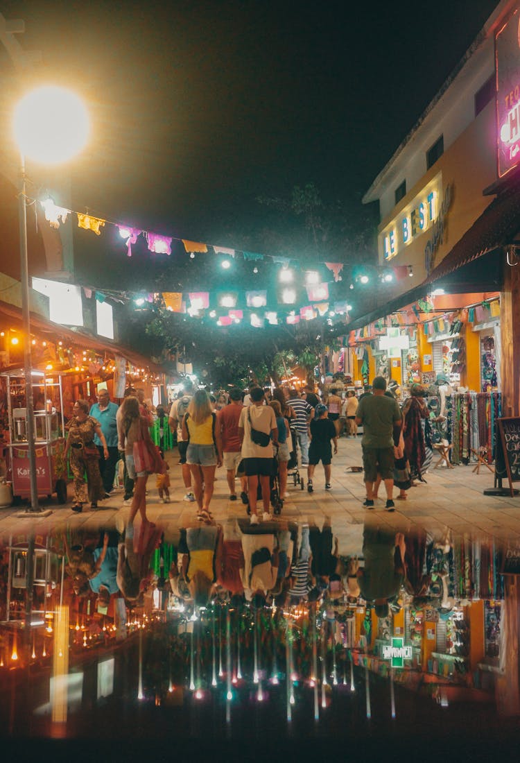 People In Illumianted Alley In Town At Night