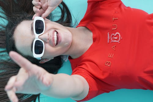 Top View of a Woman in Sunglasses and Red T-Shirt