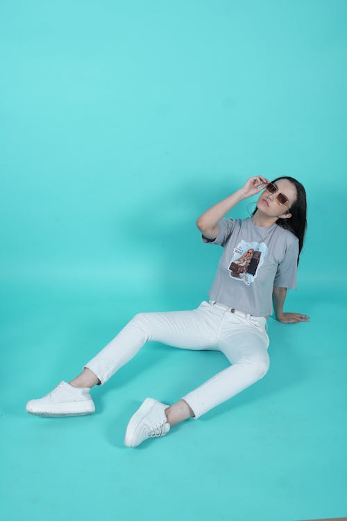 Woman Sitting and Posing in Sunglasses and T-shirt