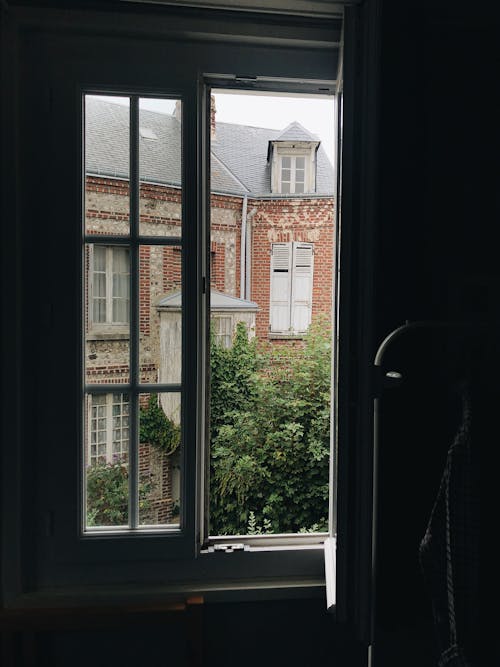 Open Window Across Red Building