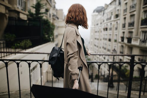 Shallow Focus Photography Of Woman Beside Fence