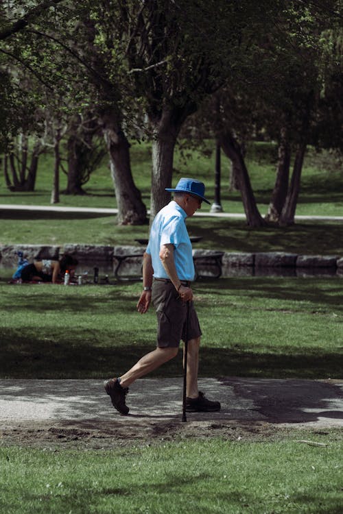 Elderly Man in Hat Walking at Park