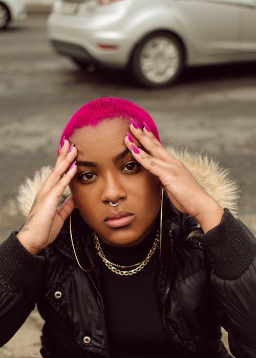 Young Woman with Short Pink Hair Posing Outdoors 