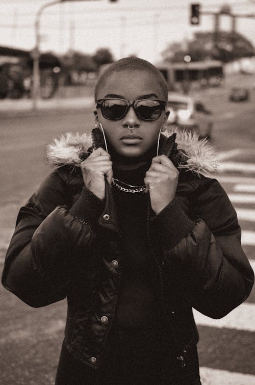 Black and White Portrait of a Young Woman Wearing a Jacket and Sunglasses 