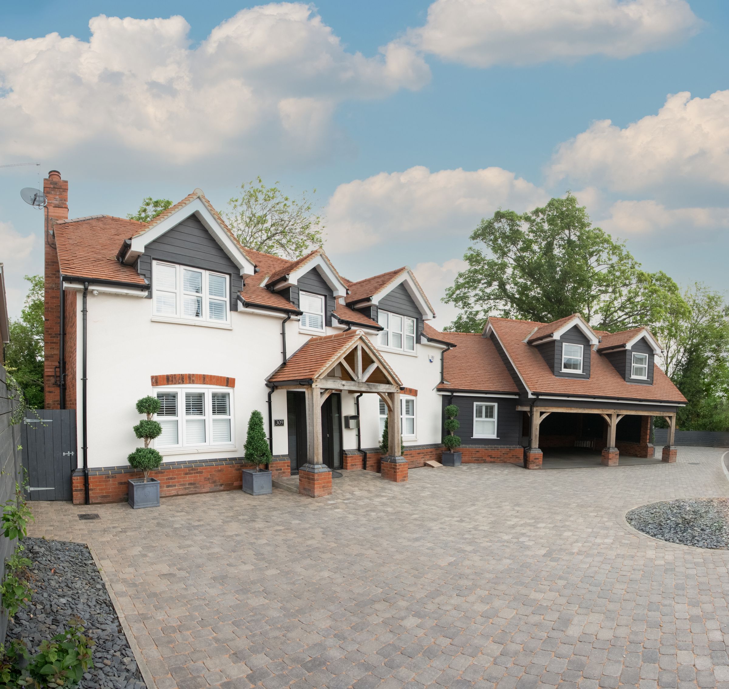 Modern British detached new-build home with stone facade and timber framing