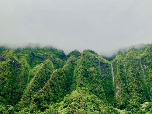 Free Foggy mountain landscape with lush green foliage and waterfalls in Kaneohe, Hawaii. Stock Photo