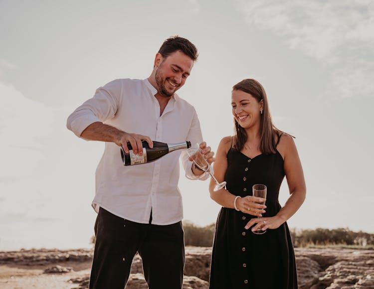 Smiling Man And Woman With Champagne