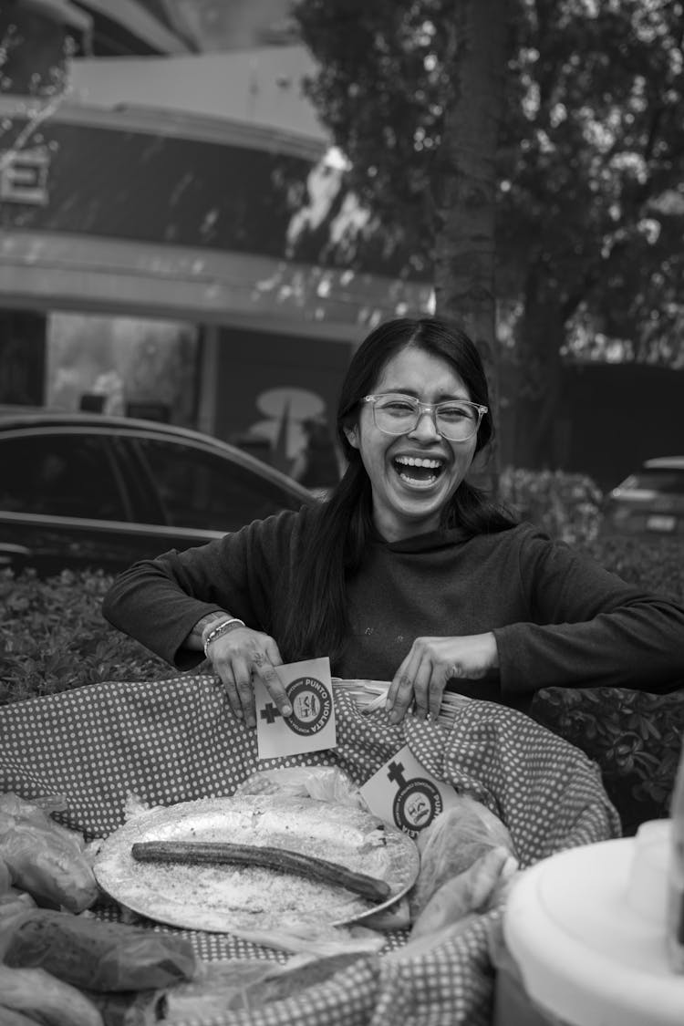 Candid Picture Of A Young Woman Laughing While Carrying A Basket Outdoors 