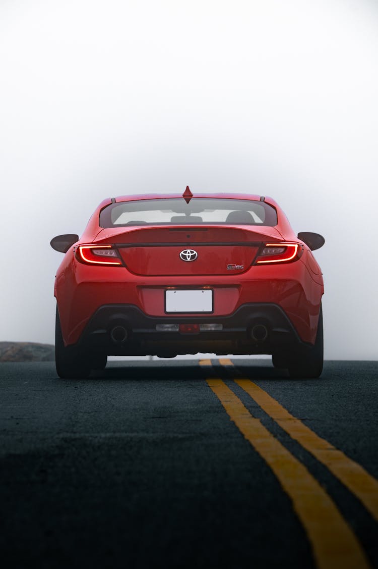 Back Of A Red Toyota GR86 On An Asphalt Road 