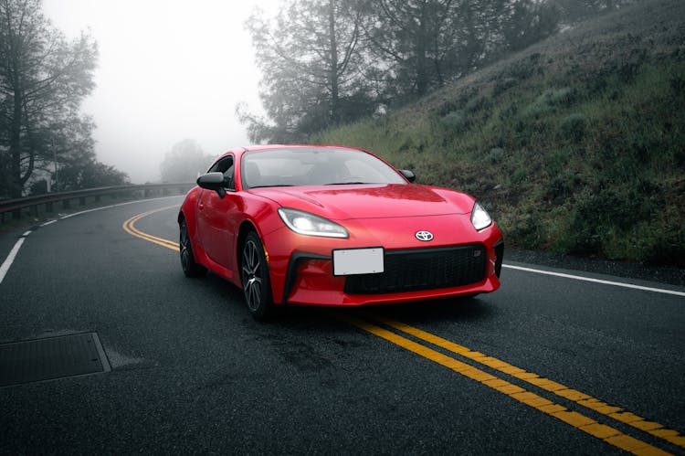 A Red Toyota GR86 On An Asphalt Road 