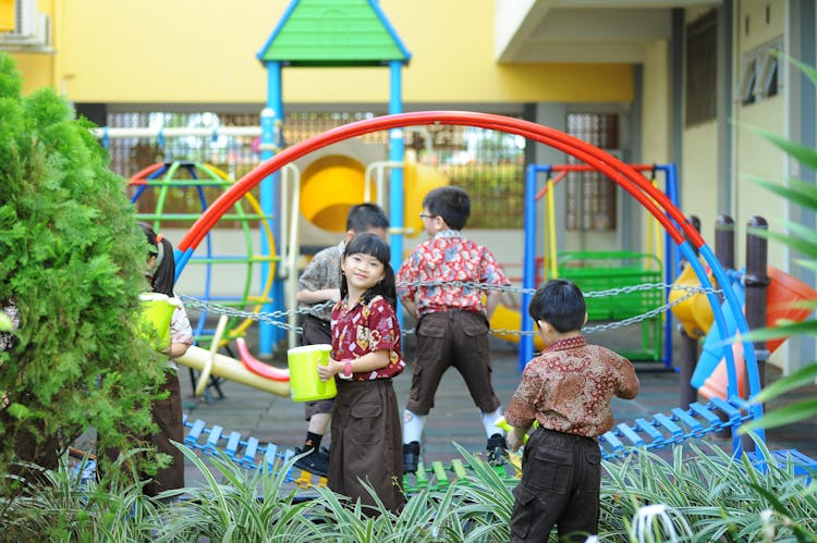 Children Playing On Playground Near School