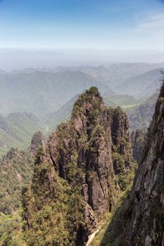 A breathtaking view of towering cliffs and lush greenery in China's Shennongjia National Park.