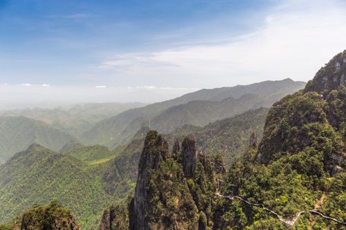 Free Stunning view of lush green mountain landscape with rocky formations and clear sky. Stock Photo