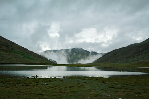 Rain Clouds over Lake among Hills