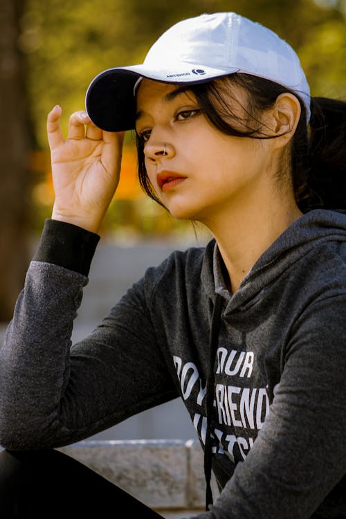 Brunette in Cap and Hoodie · Free Stock Photo