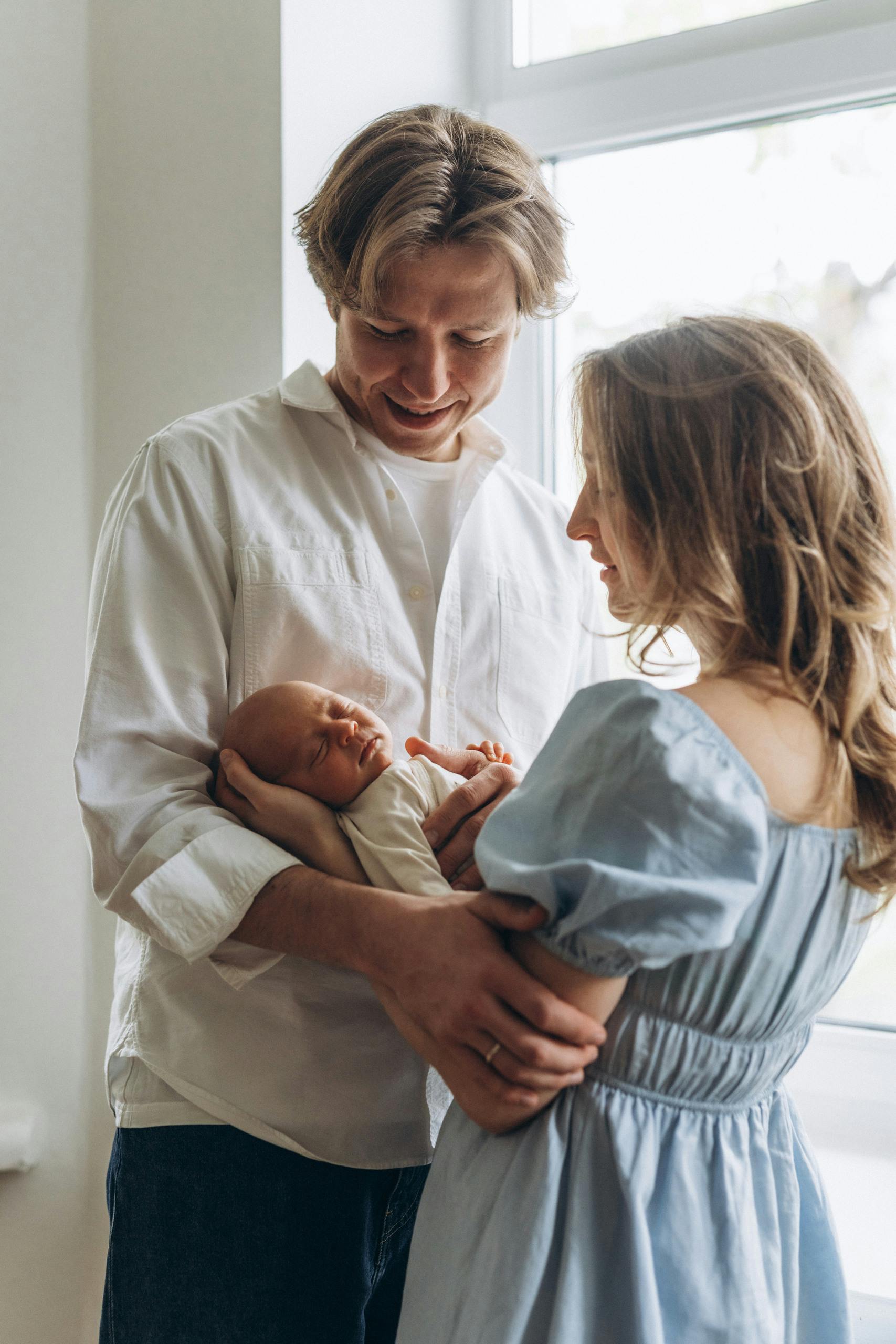 couple holding baby in arms