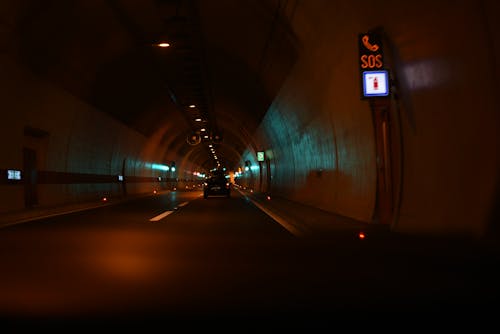 Vehicles on Tunnel Road at Nighttime