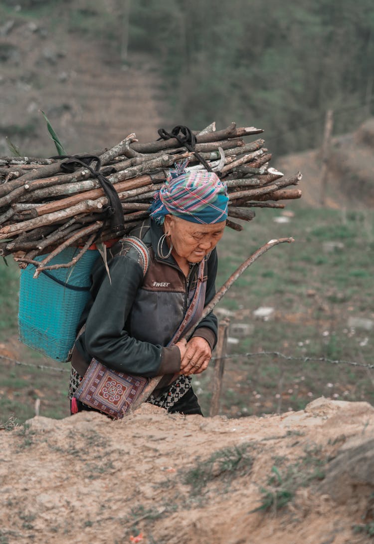 Woman Carrying Branches