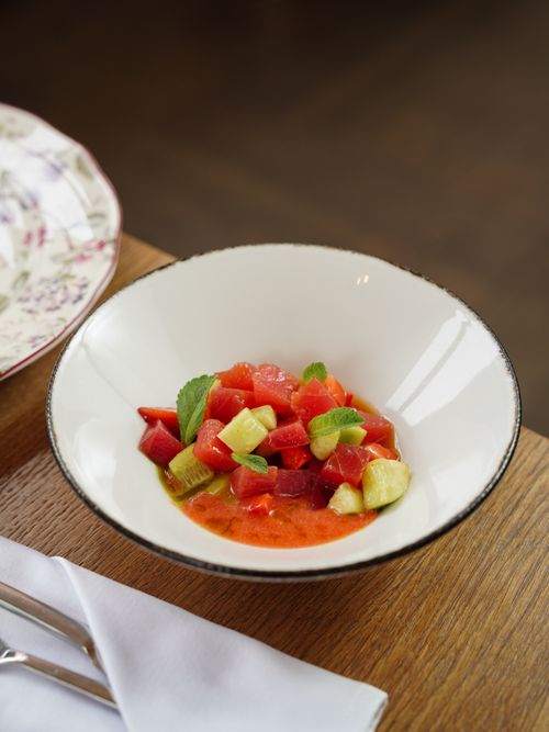 Free Colorful watermelon and cucumber salad with mint served in a bowl on wooden table. Stock Photo