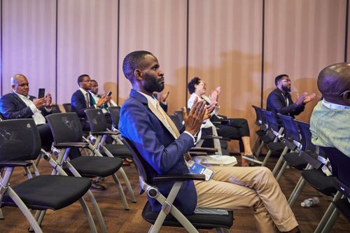 Free Diverse group clapping during a business conference with focus on engaged participation. Stock Photo