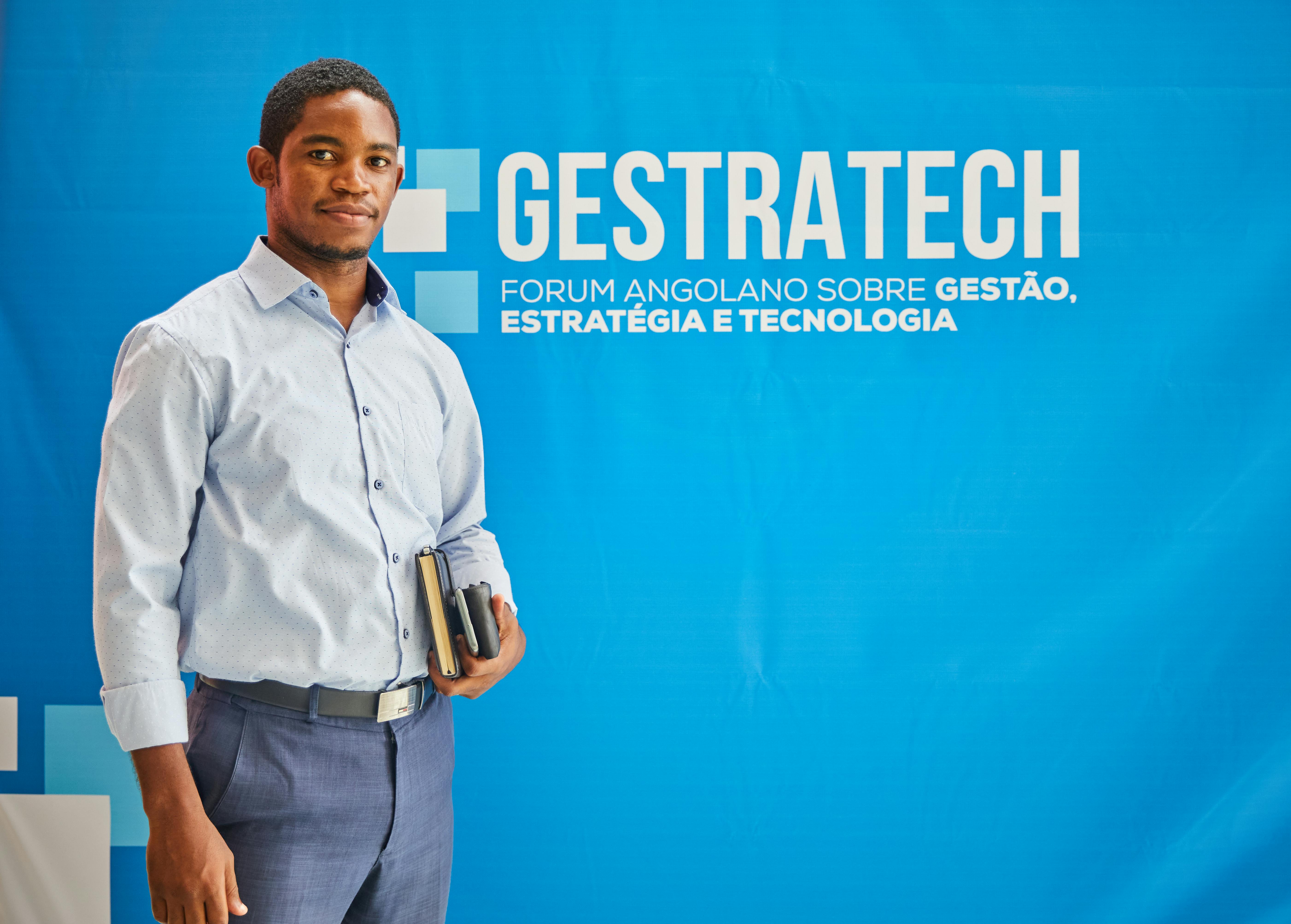 Real estate professional standing in front of a modern trade show display