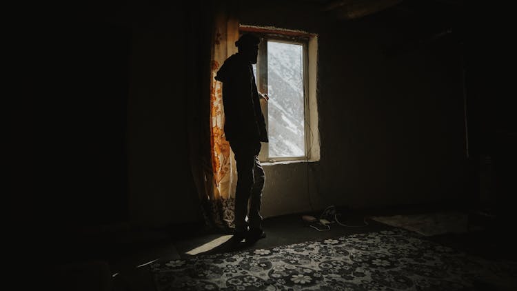 Silhouette Of Person In Dark Abandoned Room