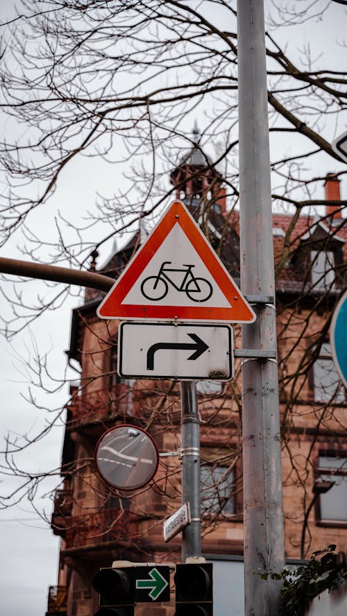 Cyclists Ahead Warning Sign and Traffic Mirror on a Lamp Pole