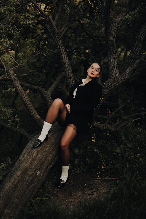 Portrait of a Female Model Lying on a Fallen Tree