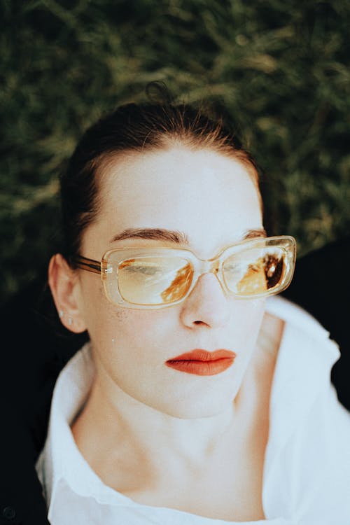Portrait of a Young Woman Wearing Eyeglasses and a Red Lipstick