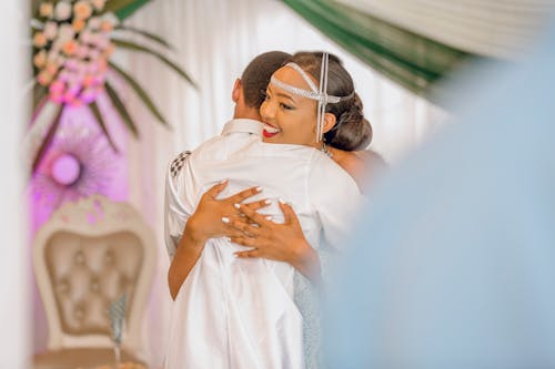 Bride Hugging a Family Member at the Wedding 