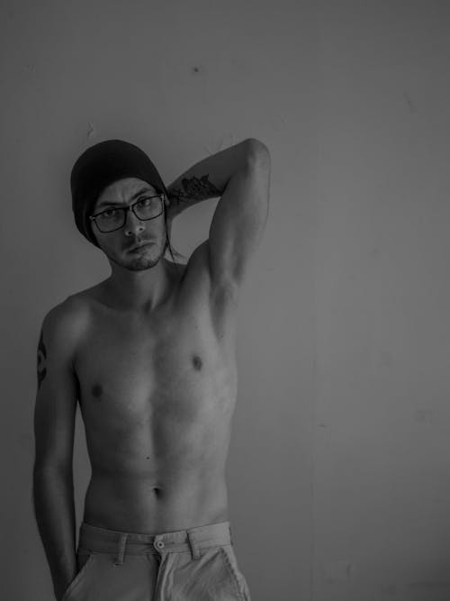 Portrait of Topless Man in Hat and Eyeglasses