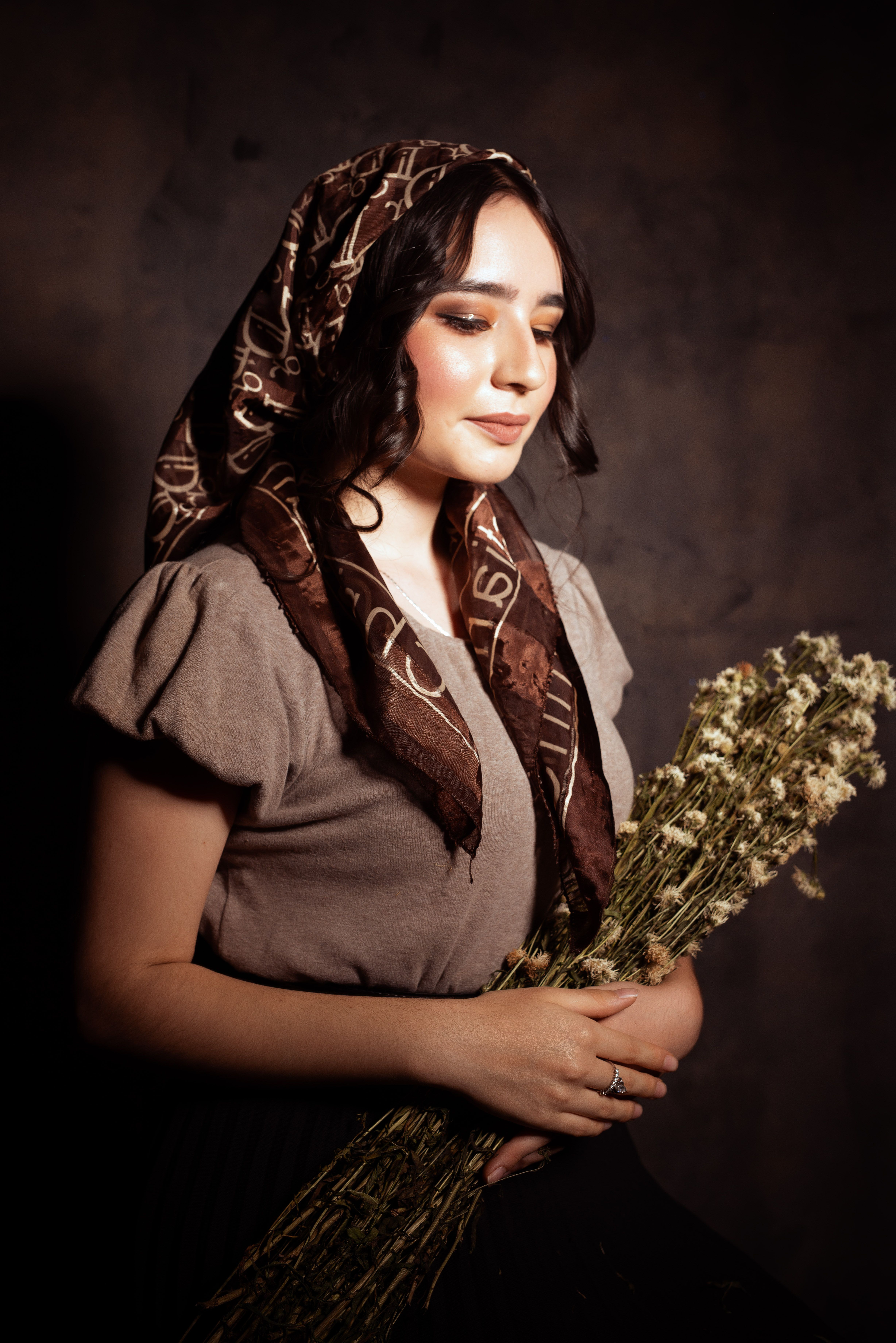 Woman in a Headscarf Holding a Bunch of Flowers · Free Stock Photo