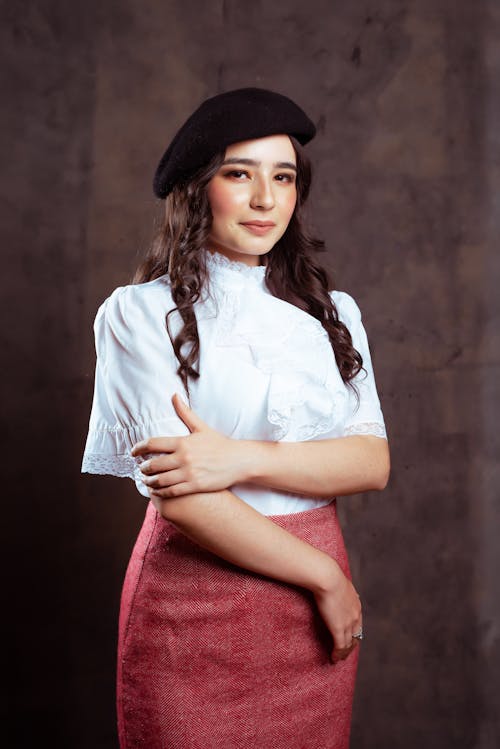 Smiling Woman with Long Curly Hair Wearing a Beret