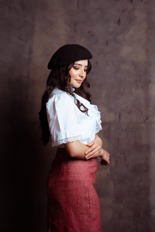 Smiling Woman with Curly Hair Standing in a Studio