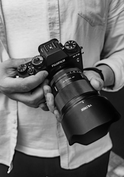 Black and White Photo of Hands Holding Camera