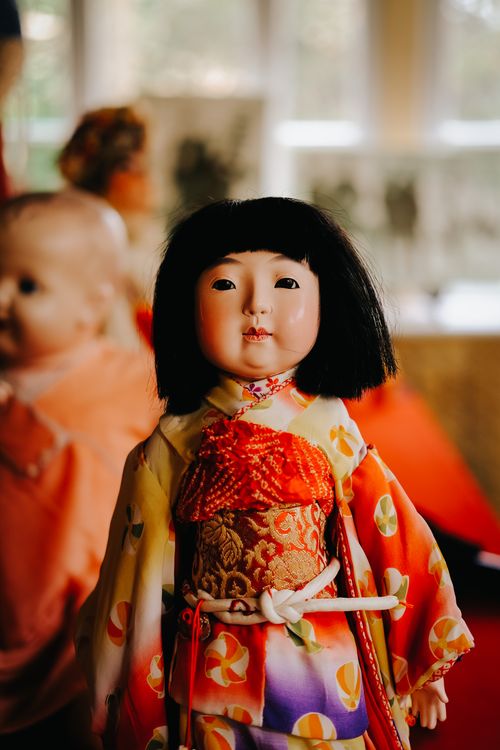 Free Close-up of a traditional Japanese porcelain doll in a colorful kimono, indoors. Stock Photo