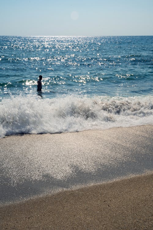 Silhouette of Man Walking into Sea