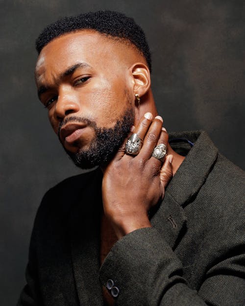 Portrait of a Man with a Beard Wearing a Suit Jacket and Rings