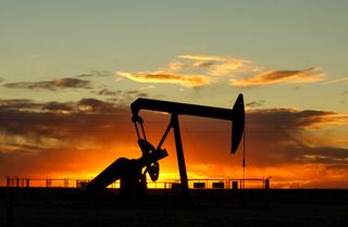 Pump jack silhouetted against a sunset — photo by Jan Zakelj on Pexels