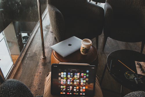 Photo of a Person Holding a Tablet in a Lobby