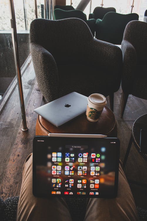 Free Tablet Screen and MacBook on Table behind Stock Photo