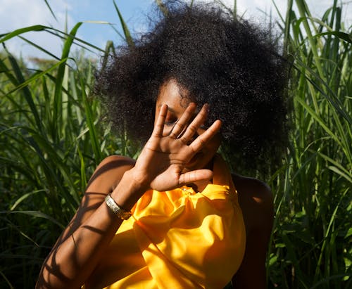 Photo of Woman Hiding Her Face Using Her Right Hand